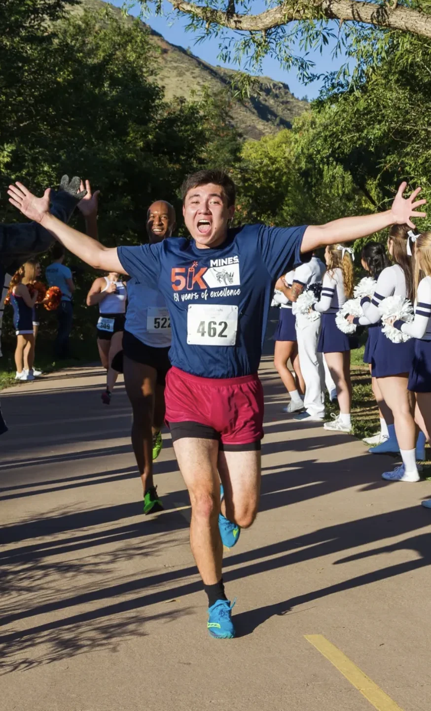 Griffin running a race with his arms outstretched