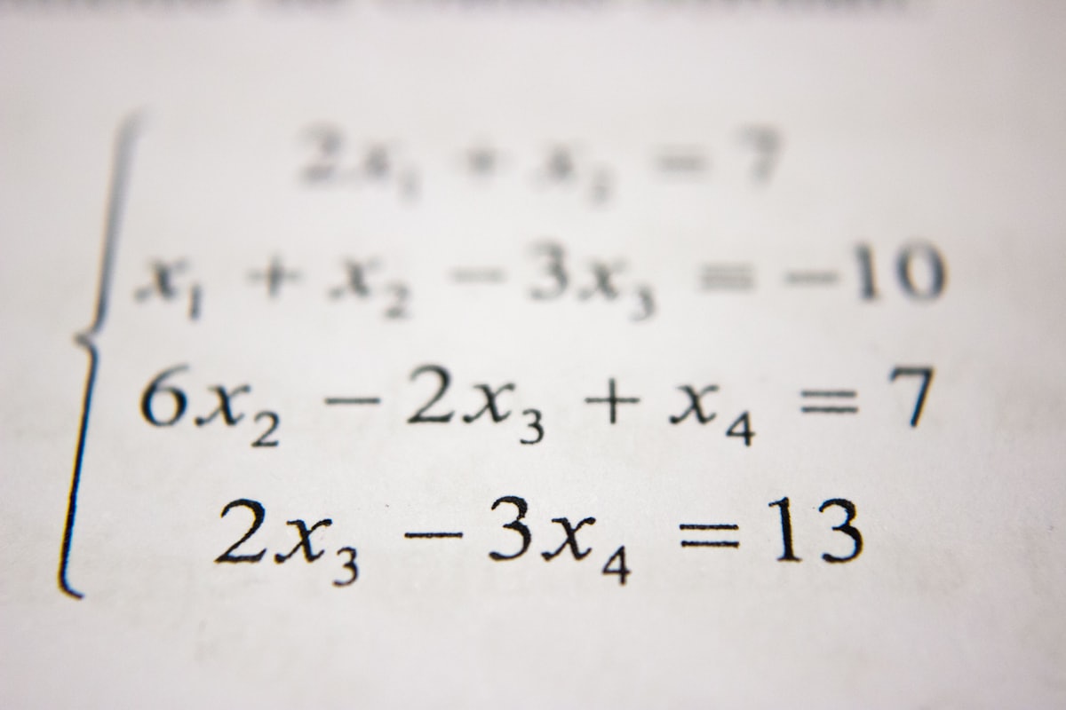 Handwritten mathematics equations and diagrams on paper